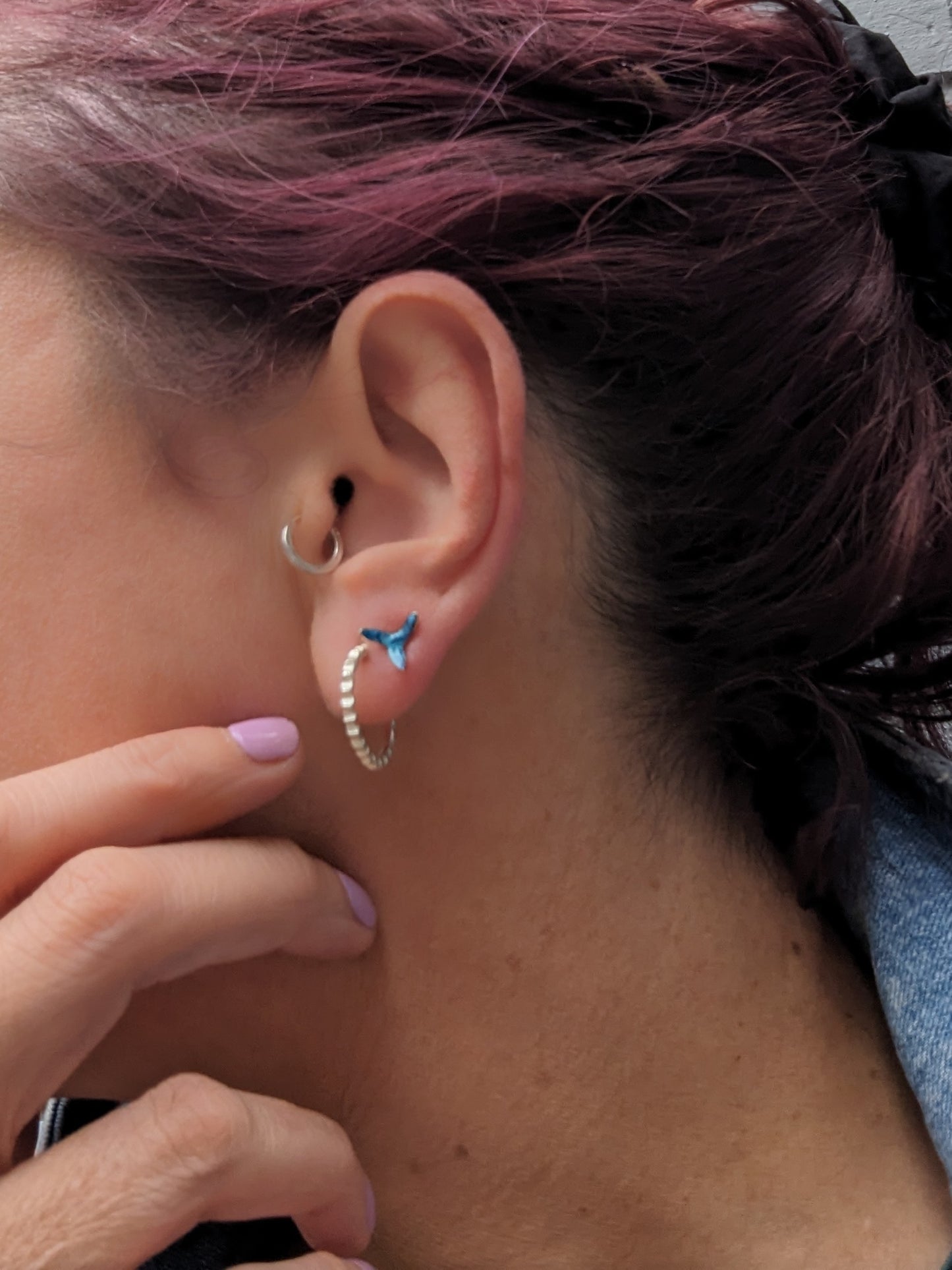 Model wearing stud earrings