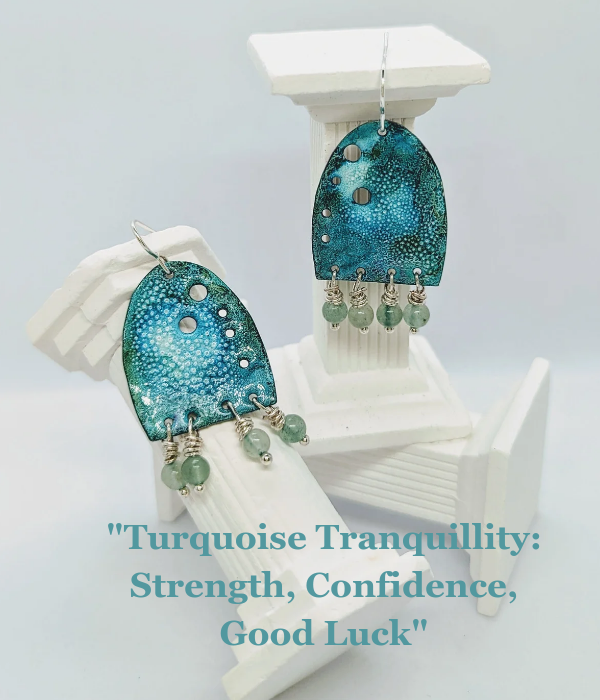 Handmade enamelled earrings in a tranquil turquoise colour, embellished with healing crystals of green aventurine. The earrings are displayed on white column. The writing in the image says "Turquoise Tranquillity: Strength, Confidence, Good Luck"
