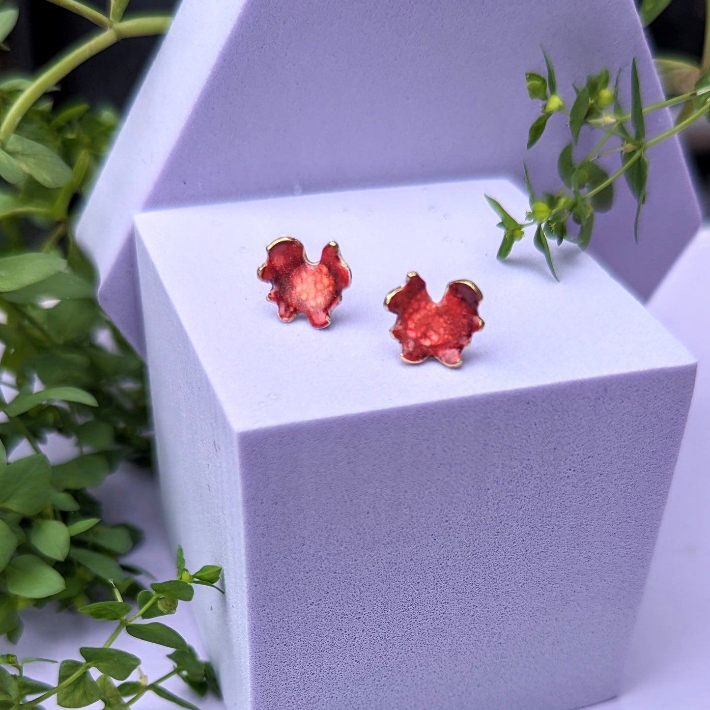 Red stud earrings on display model